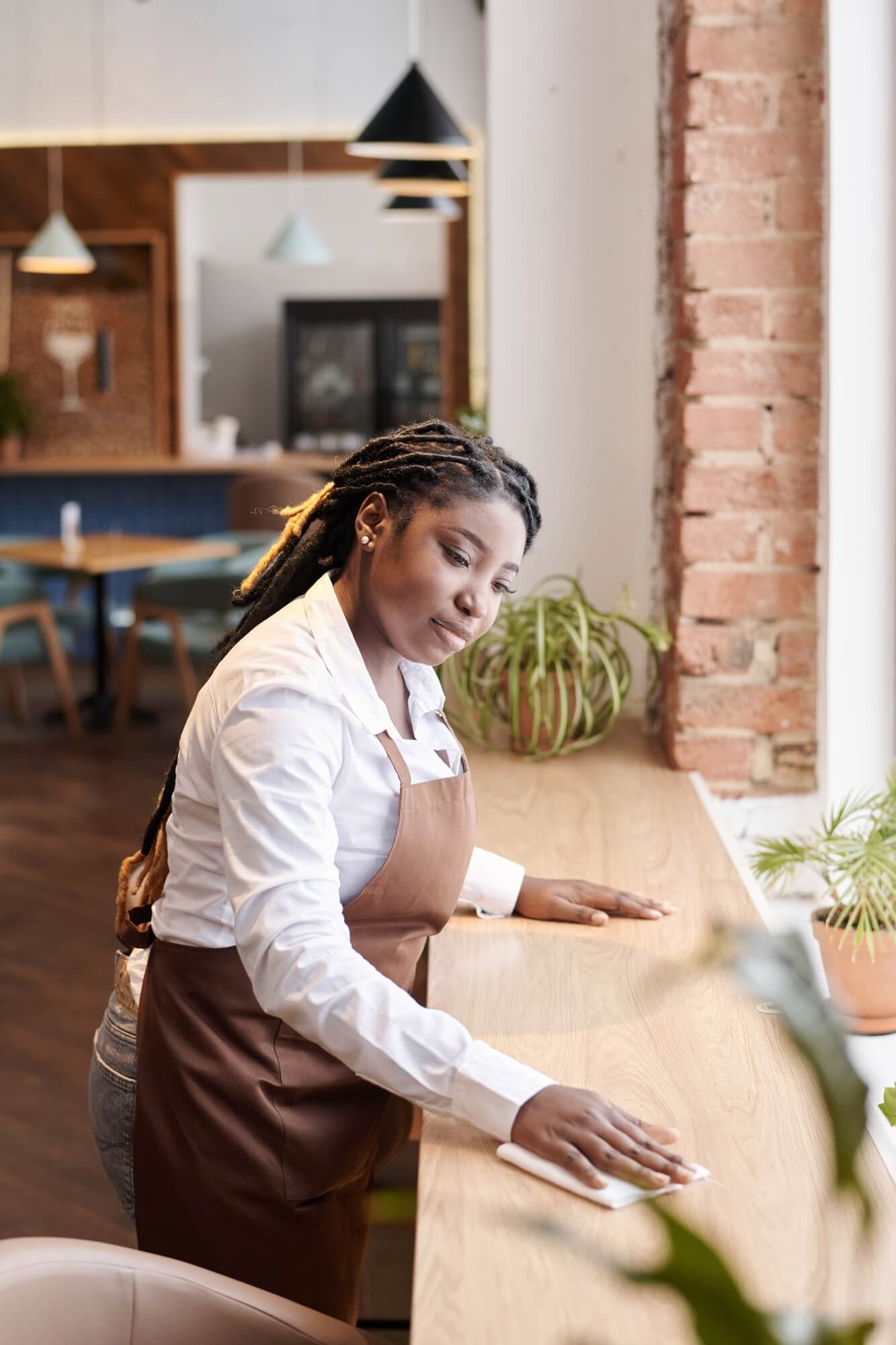 young-black-waitress-cleaning-table.jpg